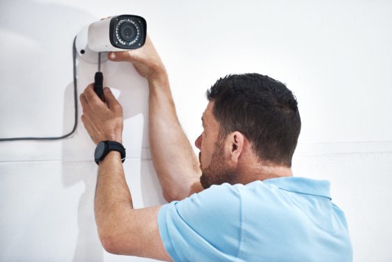 Man installing security camera inside home