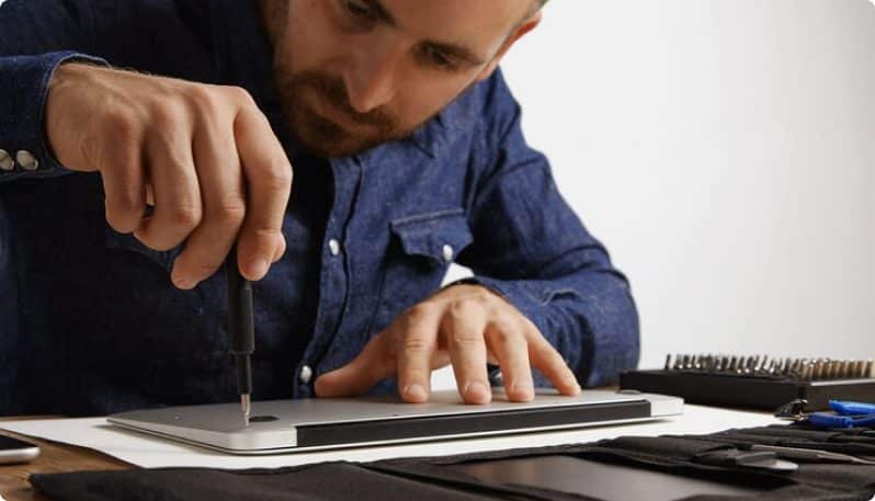 tech fixing a laptop