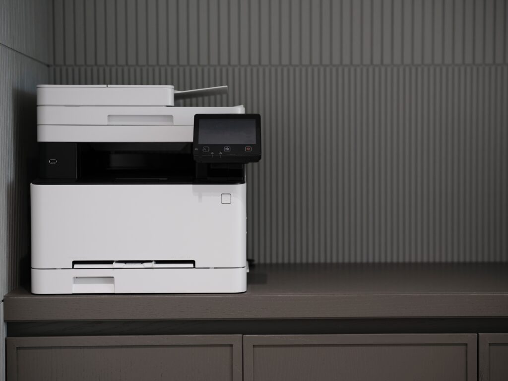 a white printer on a gray counter.