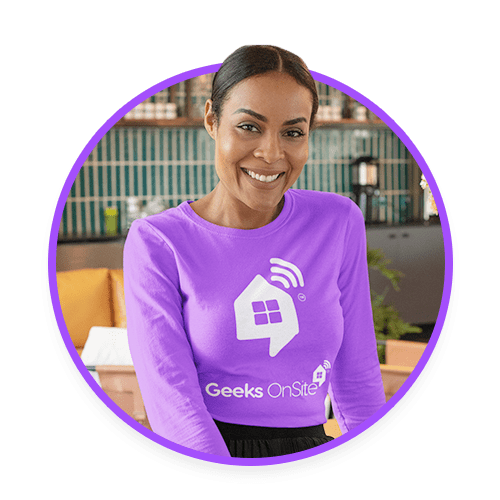 Female Geeks on Site employee in a purple long-sleeved shirt.
