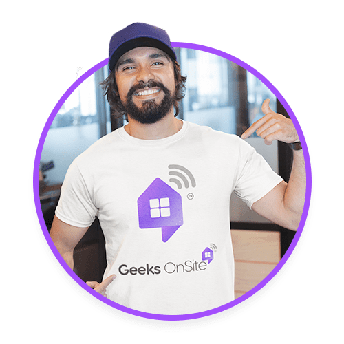 Male Geeks on Site employee with a beard in a hat and white branded shirt.