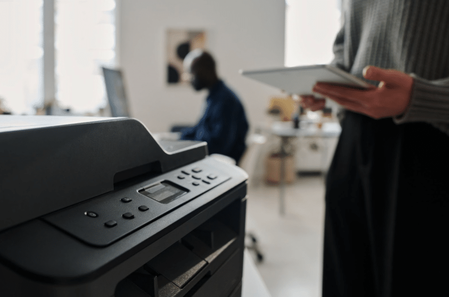 person pressing button on printer
