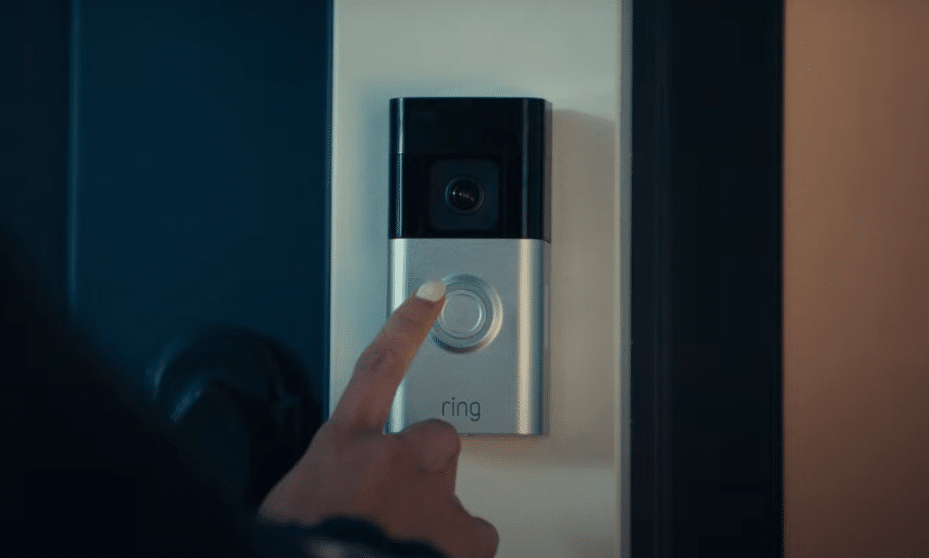 woman pressing button on ring camera
